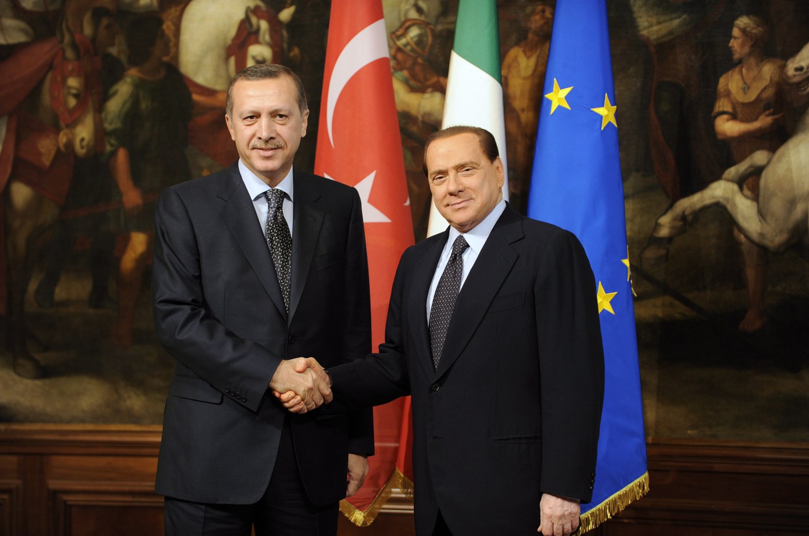 Then-Prime Minister Recep Tayyip Erdoğan shakes hands with Italian Prime Minister Silvio Berlusconi (R) during their meeting at Chigi Palace in Rome, Italy, Nov. 17, 2009. (EPA File Photo)