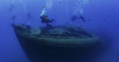 Divers dive near the French warship Paris 2, Kemer, Antalya, Türkiye, June 18, 2023. (DHA Photo)