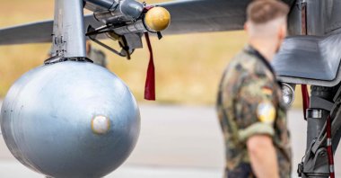 A German Armed Forces (Bundeswehr) soldier looks at an Iris-T System attached above the tank of a German ECR Tornado aircraft at the military air base in Jagel, southern Germany, during the Air Defender Exercise 2023, June 16, 2023.