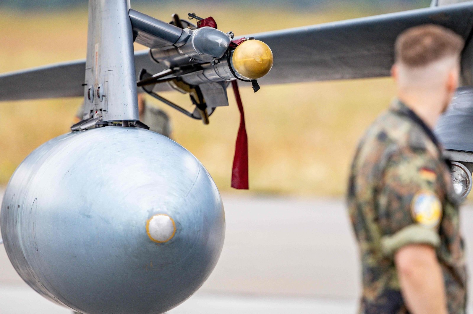 A German Armed Forces (Bundeswehr) soldier looks at an Iris-T System attached above the tank of a German ECR Tornado aircraft at the military air base in Jagel, southern Germany, during the Air Defender Exercise 2023, June 16, 2023.