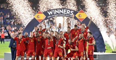 Spain&#039;s players celebrate on the podium with the UEFA Nations League cup after winning the penalty shootouts and the UEFA Nations League final football match between Croatia and Spain at the De Kuip Stadium, Rotterdam, Netherlands, June 18, 2023. (AFP Photo)
