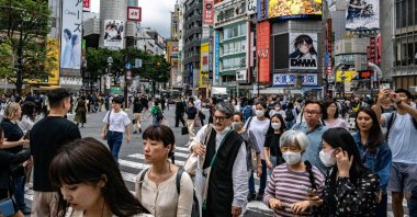 People walk across "Shibuya Crossing" in the Shibuya district of Tokyo, Japan, June 14, 2023. (AFP Photo)