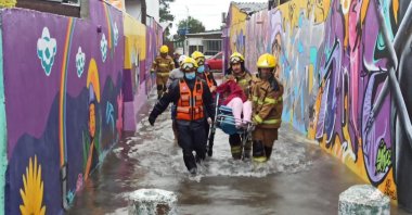 Firemen carry a person in a flooded street in Porto Alegre, Rio Grande do Sul State, Brazil, June 16, 2023. (AFP Photo)