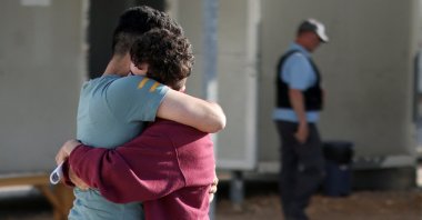 Syrian survivor Mohammad, 18, who was rescued with other refugees and migrants at open sea off Greece after their boat capsized, reunites with his brother Fadi, inside a reception and identification camp in Malakasa, Greece, June 18, 2023. (Reuters Photo)