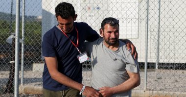 Egyptian survivor Atia Al Said (L), 22, reunites with his uncle Mohamed el Sayed el-Dadamony Radwan, 54, inside a reception and identification camp in Malakasa, Greece, June 18, 2023. (Reuters Photo)