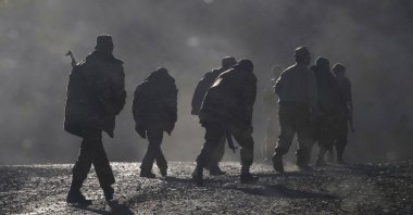 Ethnic Armenian soldiers walk along the road near the border between Karabakh and Armenia, Nov. 8, 2020. (AP File Photo)