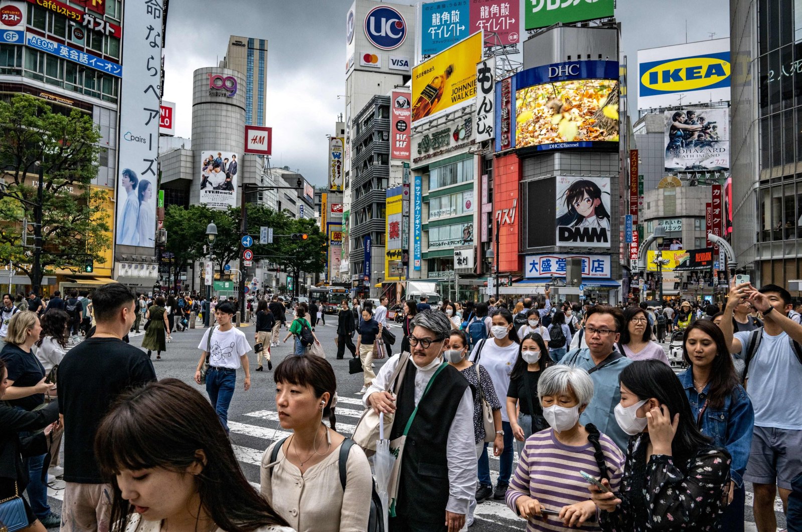 People walk across &quot;Shibuya Crossing&quot; in the Shibuya district of Tokyo, Japan, June 14, 2023. (AFP Photo)