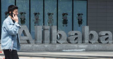 A man walks past Chinese e-commerce giant Alibaba&#039;s headquarters in Hangzhou, in China&#039;s eastern Zhejiang province, May 26, 2022. (AFP Photo)