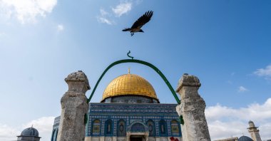 A crow flies near the Dome of the Rock mosque as tourists visit the Al-Aqsa Mosque compound in the occupied Jerusalem, Palestine, June 18, 2023. (AFP Photo)