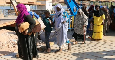 Sudanese people disembark after traversing the Nile River on a ferry after crossing the border from Sudan, Abu Simbel, Egypt, May 20, 2023. (EPA Photo)