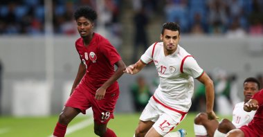  Qatar's Yusuf Abdurisag in action with Oman's Ali Al-Busaidi in 2022 World Cup Qualifier Round 2 game at Al Janoub Stadium in Al Wakrah, Qatar, Oct. 15, 2019. (Reuters File Photo)