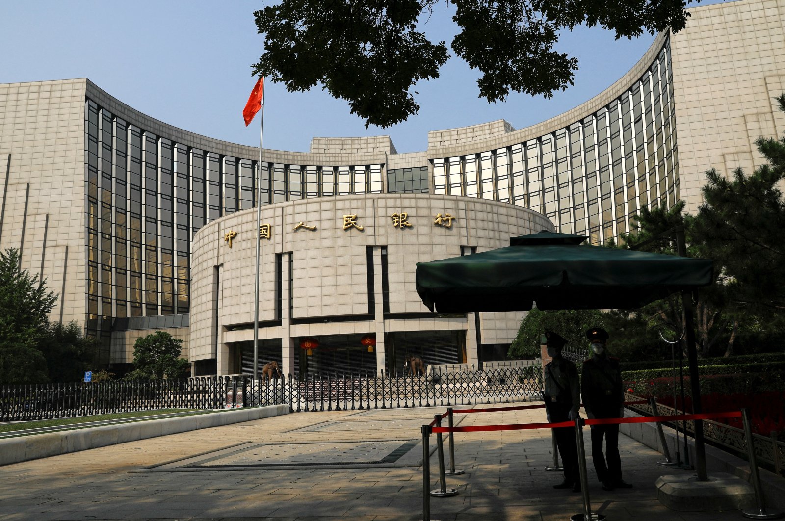 Paramilitary police officers stand guard in front of the headquarters of the People&#039;s Bank of China, the central bank (PBOC), in Beijing, China, Sept. 30, 2022. (Reuters Photo)