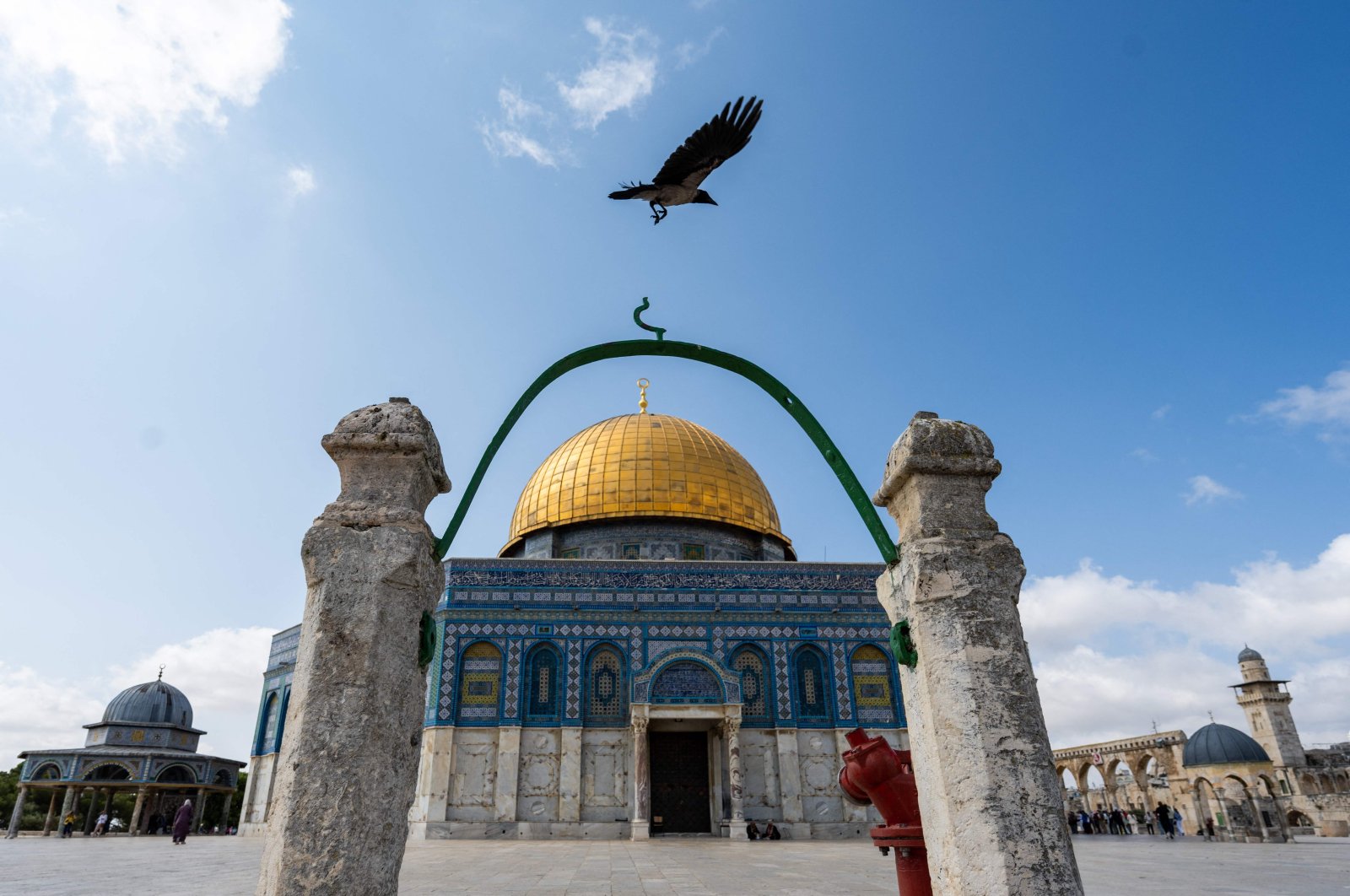 A crow flies near the Dome of the Rock mosque as tourists visit the Al-Aqsa Mosque compound in the occupied Jerusalem, Palestine, June 18, 2023. (AFP Photo)