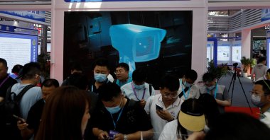 Visitors stand in front of a screen displaying the police&#039;s public security technology at Security China, an exhibition on public safety and security, in Beijing, China, June 7, 2023. (Reuters Photo)