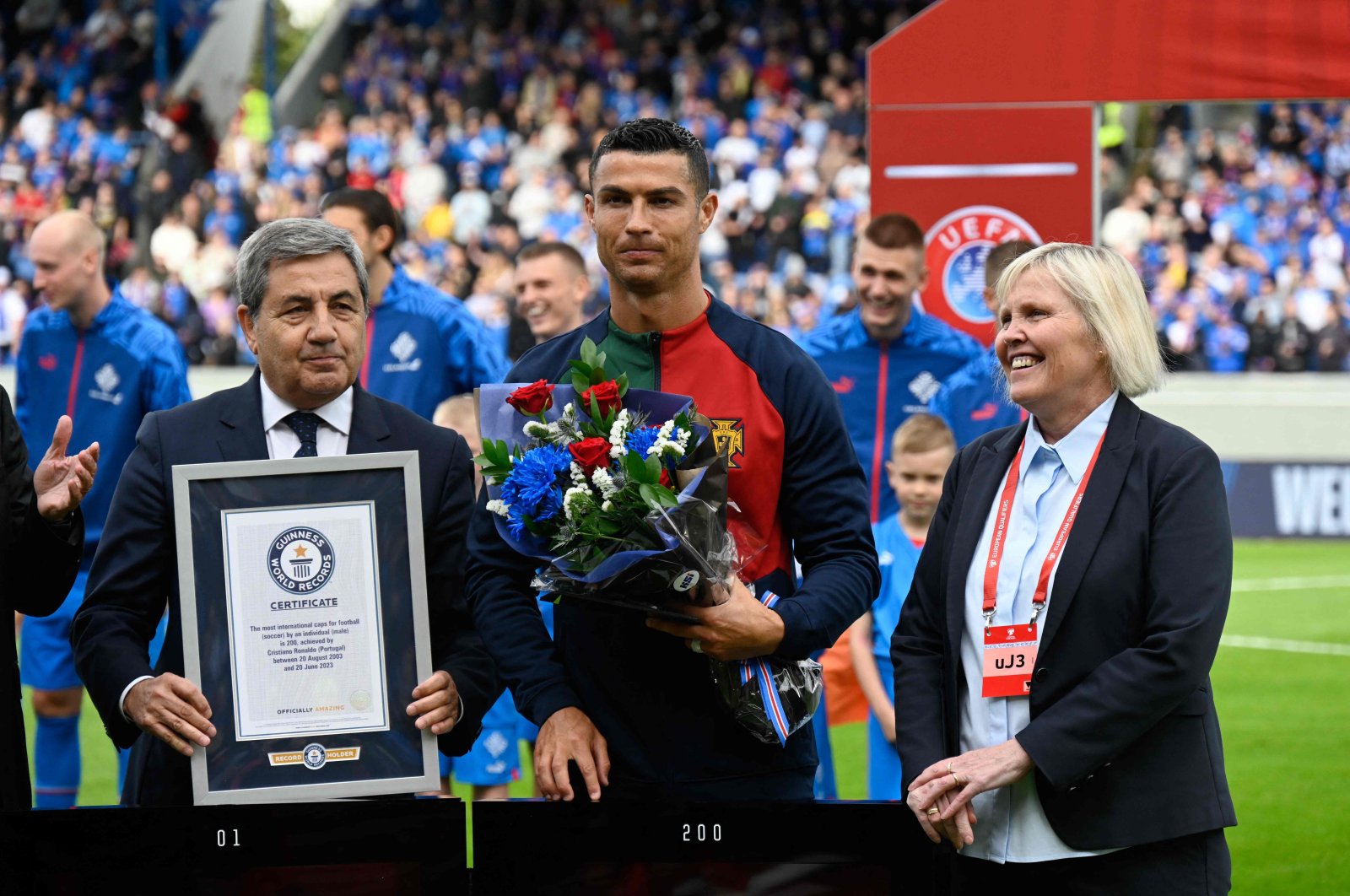 Portugal&#039;s forward Cristiano Ronaldo (C) is honored with a certificate of the Guinness World Records for having achieved 200 goals within almost 20 years of his career, prior to the UEFA Euro 2024 group J qualification football match between Iceland and Portugal, Reykjavik on June 20, 2023. (AFP Photo)