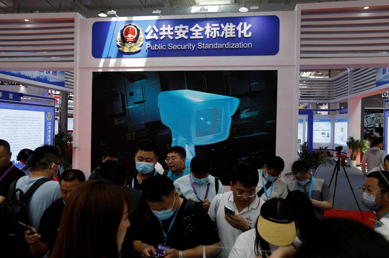 Visitors stand in front of a screen displaying the police&#039;s public security technology at Security China, an exhibition on public safety and security, in Beijing, China, June 7, 2023. (Reuters Photo)