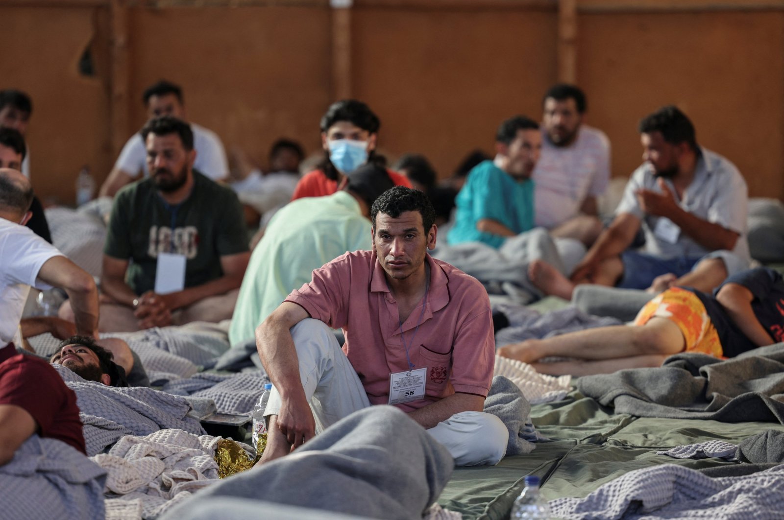Migrants rest in a shelter, following a rescue operation, after their boat capsized in the open sea, Kalamata, Greece, June 14, 2023. (Reuters Photo)