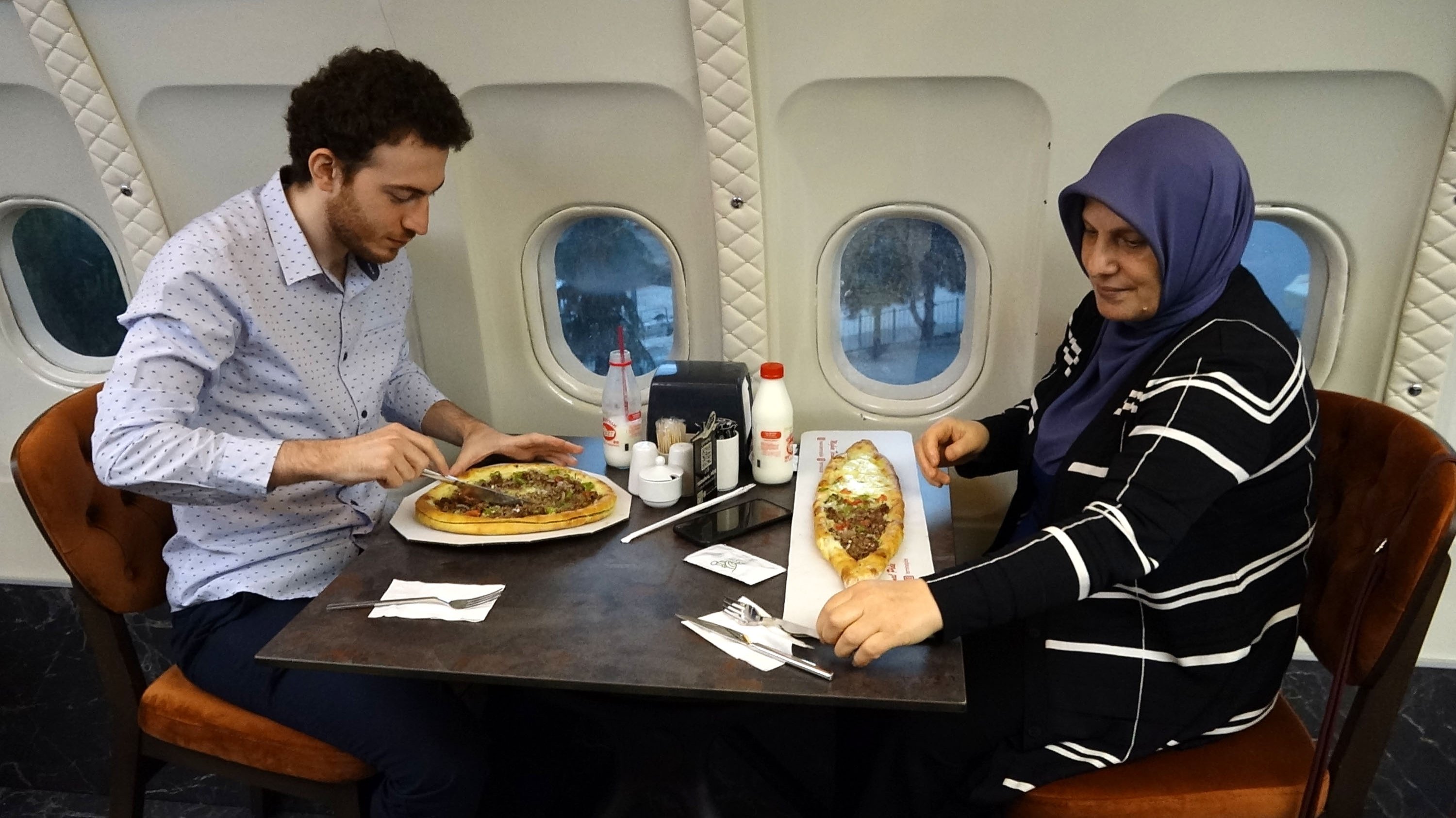 Passengers, who survived the airplane skidding off the runway, dine in the pide salon, Trabzon, northern Türkiye, June 22, 2023. (DHA Photo)