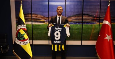 Fenerbahçe's new striker Edin Dzeko poses for a photo with a jersey after signing a two-year contract with the Turkish club in Istanbul, Türkiye, June 22, 2023. (AA Photo)
