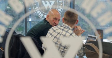 Men speak inside PMC Wagner Centre, which is a project implemented by the businessperson and founder of the Wagner private military group Yevgeny Prigozhin, during the official opening of the office block in St.Petersburg, Russia, Nov. 4, 2022. (Reuters File Photo)