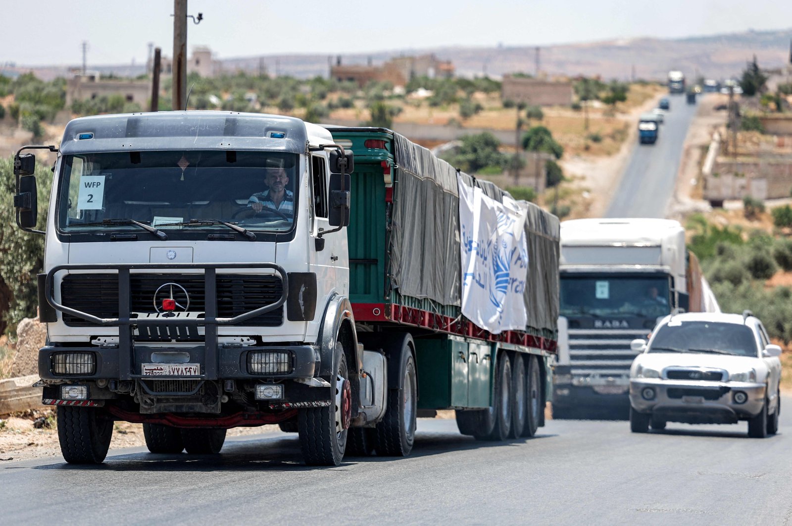 Trucks move in a United Nations aid convoy en route to Syria&#039;s opposition-held northwestern city of Idlib, June 23, 2023. (AFP Photo)