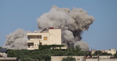 A plume of smoke rises from a building following a reported Russian air strike, in Idlib, Syria, June 25, 2023. (AFP Photo)