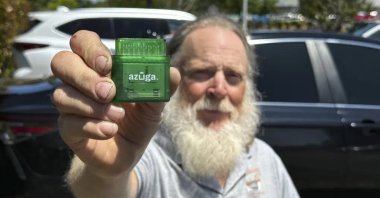 Evan Burroughs displays a tracking device the program he developed uses, in Salem, Ore., U.S., June 21, 2023. (AP Photo)