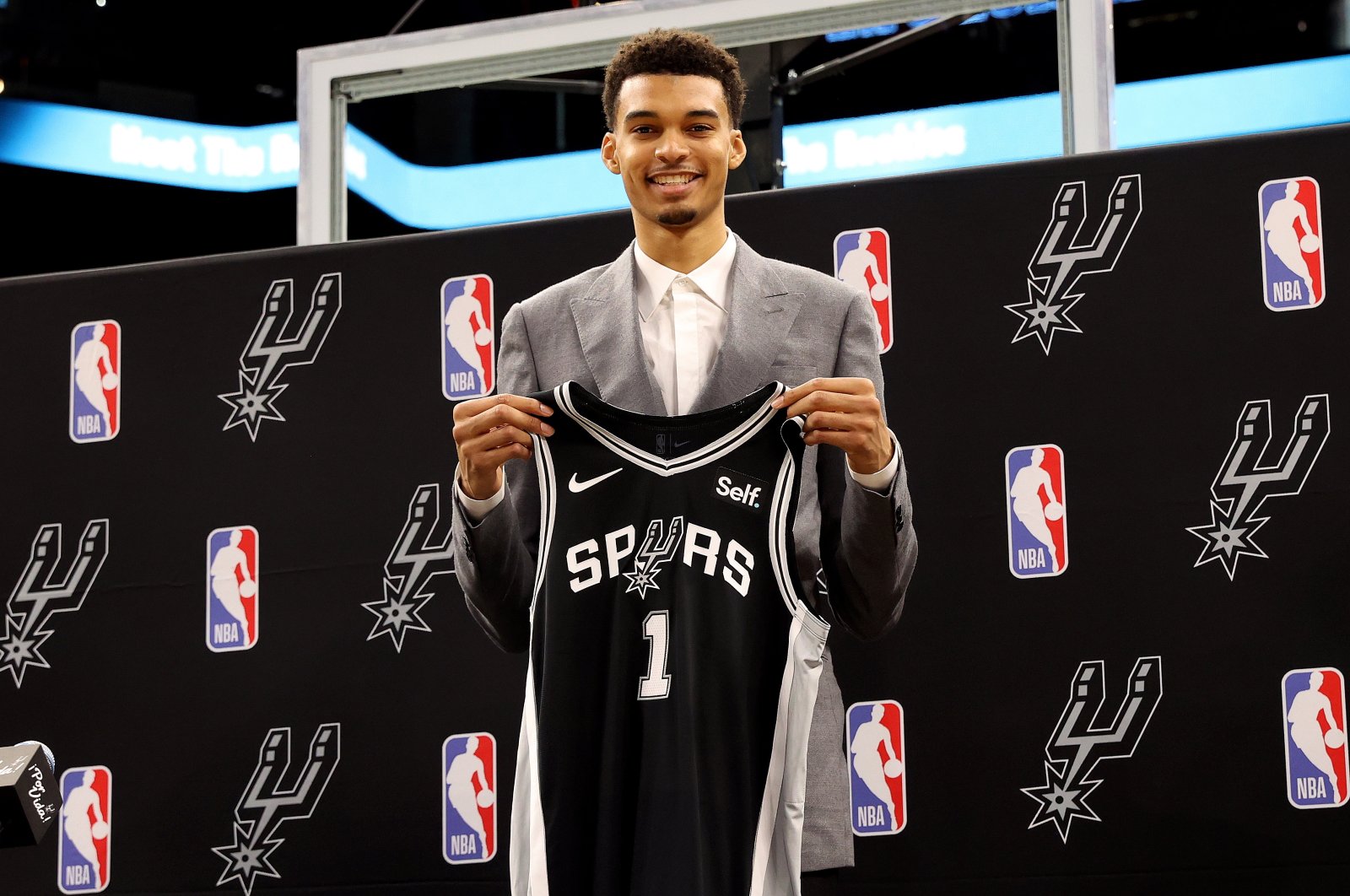 San Antonio Spurs first round pick Victor Wembanyama of France poses with his jersey during a press conference at the AT&amp;T Center, Texas, U.S., June 24, 2023. (EPA Photo)