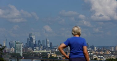 A person looks at the City of London financial district over from Greenwich Park, in London, Britain June 22, 2023. (REUTERS/Hannah McKay)