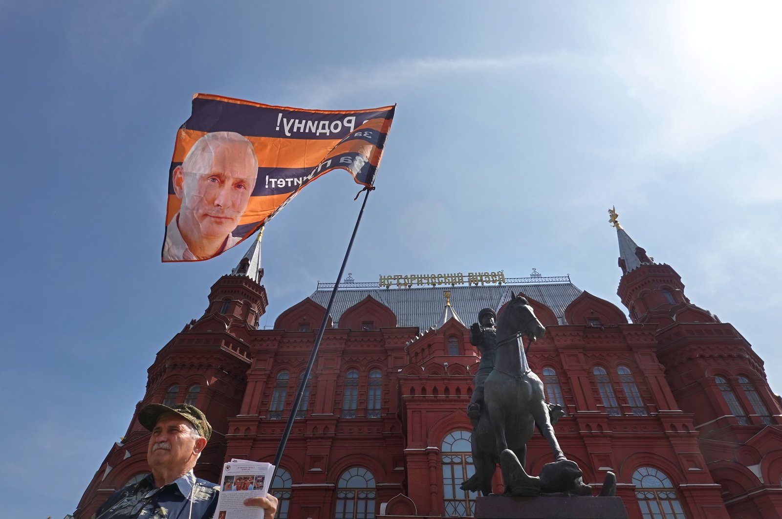 A member of the National Liberation Movement (NLM) holds a flag with a portrait of Russian President Putin in Moscow, Russia, June 25, 2023. (EPA Photo)