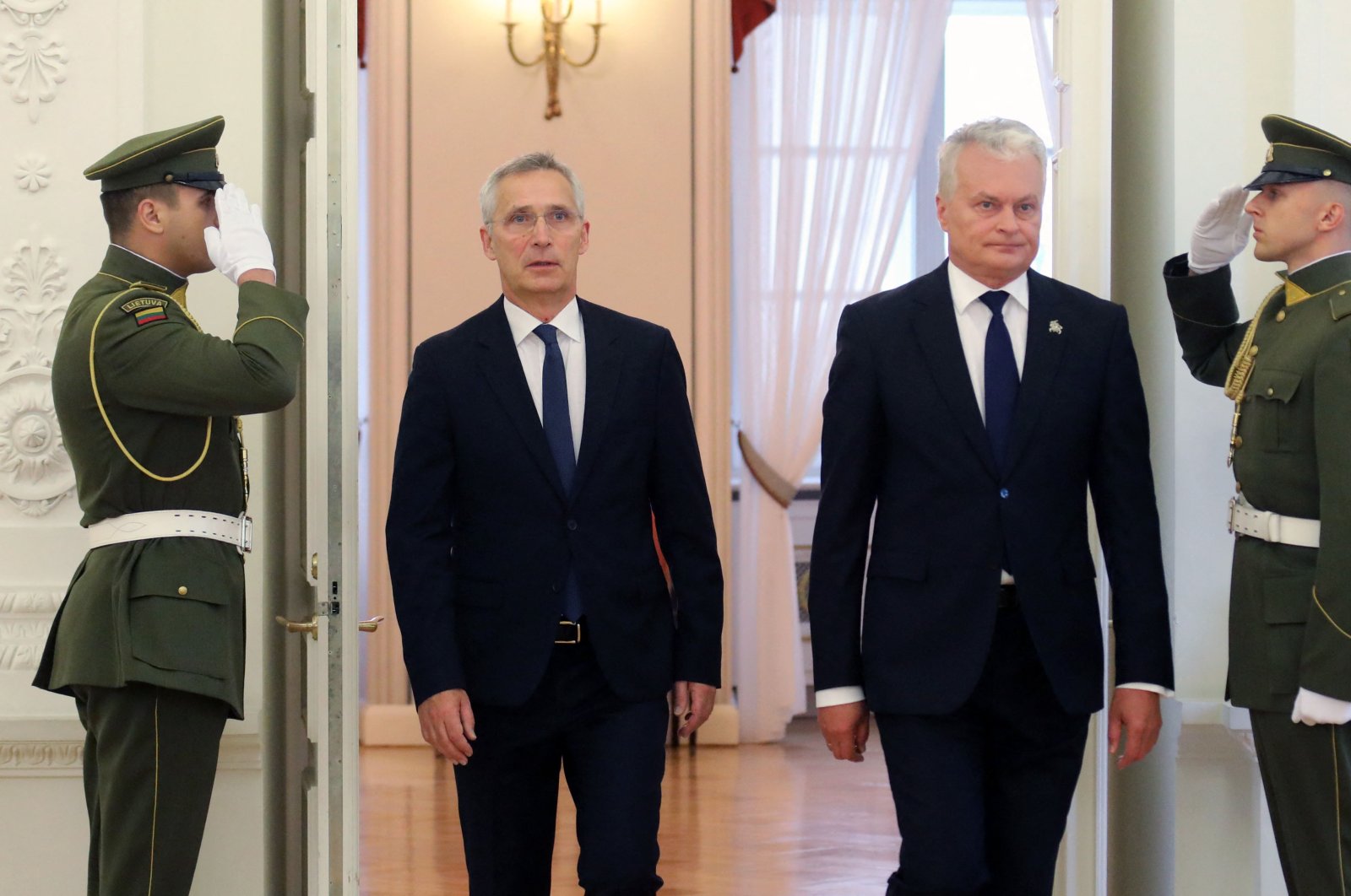 NATO Secretary-General Jens Stoltenberg (L) is welcomed by Lithuania&#039;s President Gitanas Nauseda (R) in Vilnius, Lithuania, June 26, 2023. (AFP Photo)
