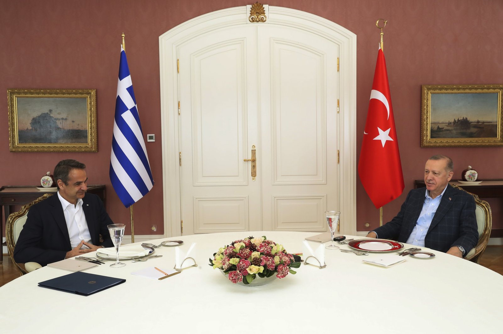 In this photo provided by Turkish Presidency, President Recep Tayyip Erdoğan and Greek Prime Minister Kyriakos Mitsotakis talk during their meeting in Istanbul, Türkiye, Sunday, March 13, 2022. (Turkish Presidency via AP, File)