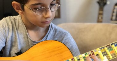 A still shot taken from the performance by Can Sayar as plays LEGO microtonal guitar.