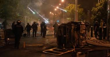 Fireworks explode over the heads of French riot police during protests in Nanterre, west of Paris, France, June 28, 2023. (AFP Photo)