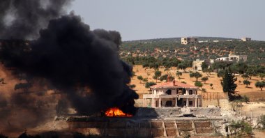 A plume of smoke rises from a building following a reported Russian air strike on Idlib province, northwestern Syria, June 25, 2023. (AFP Photo)