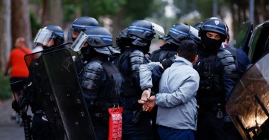 Police officers arrest a man during protests two days after a teenager was shot dead during a police traffic stop in the Paris suburb of Nanterre, Lille, France, June 29, 2023. (AFP Photo)