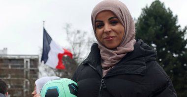 Writer Majid Siham poses with a football during a gathering to support the women&#039;s team &quot;Les Hijabeuses&quot; in front of the city hall in Lille as part of a protest as the French Senate examines a bill featuring a controversial hijab ban in competitive sports, Paris, France, Feb. 16, 2022. (Reuters Photo)