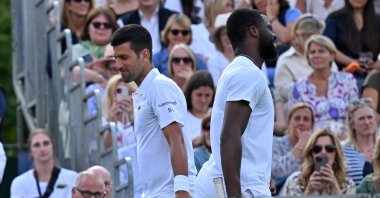 US player Frances Tiafoe (R) and Serbia's Novak Djokovic share a joke as they pass during their men's singles exhibition match at The Giorgio Armani Tennis Classic tournament at the Hurlingham Club, London, UK., June 29, 2023. (AFP Photo)