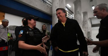 Former Brazilian President Jair Bolsonaro greets a military police officer upon arrival at the Santos Dumont Airport, Rio de Janeiro, Brazil, June 29, 2023.  (AFP Photo)