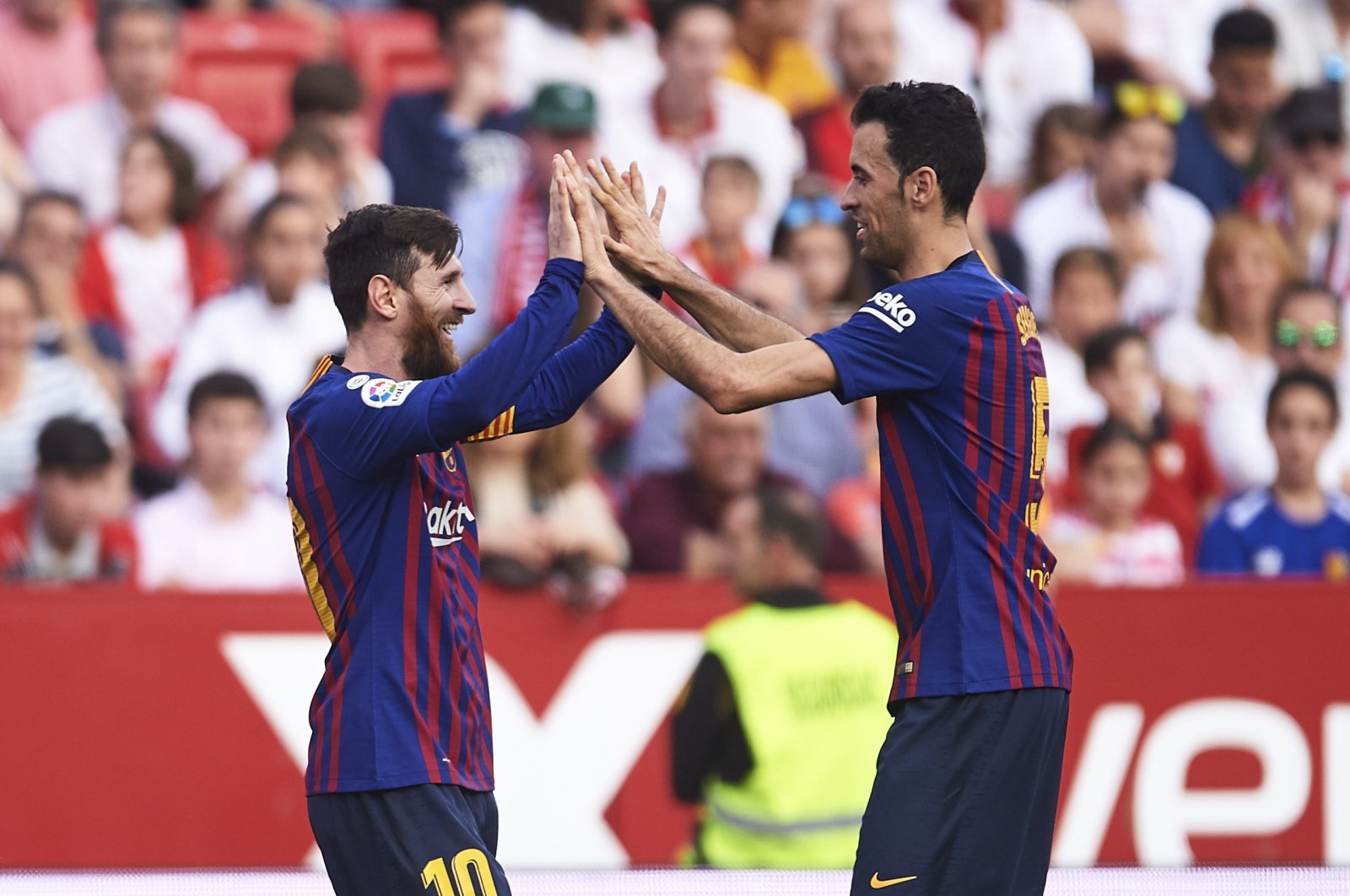 Former Barcelona players, Lionel Messi (L) and Sergio Busquets celebrate after Messi&#039;s goal against Sevilla at the Camp Nou, Barcelona, Spain, Feb. 23, 2019. (Getty Images Photo)