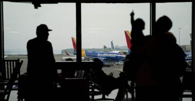 Southwest Airlines aircraft are seen past travelers ahead of the Fourth of July holiday, at Ronald Reagan Washington National Airport in Arlington, Virginia, U.S., July 1, 2023. (AFP Photo)