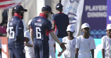 Members of the U.S. cricket team greet young boys at Takashinga Cricket Club in Highfields, Harare, Zimbabwe, June, 18, 2023. (AP Photo)