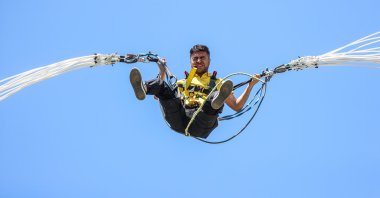 A man is seen jumping off one of the trails with a rope, Bursa, northwestern Türkiye, July 3, 2023. (AA Photo)