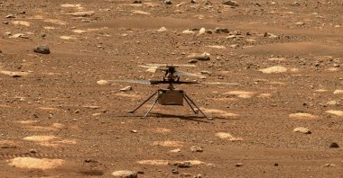 The Ingenuity helicopter unlocks its rotor blades, as seen from the Perseverance Mars rover, Mars, April 7, 2021. (AFP Photo)