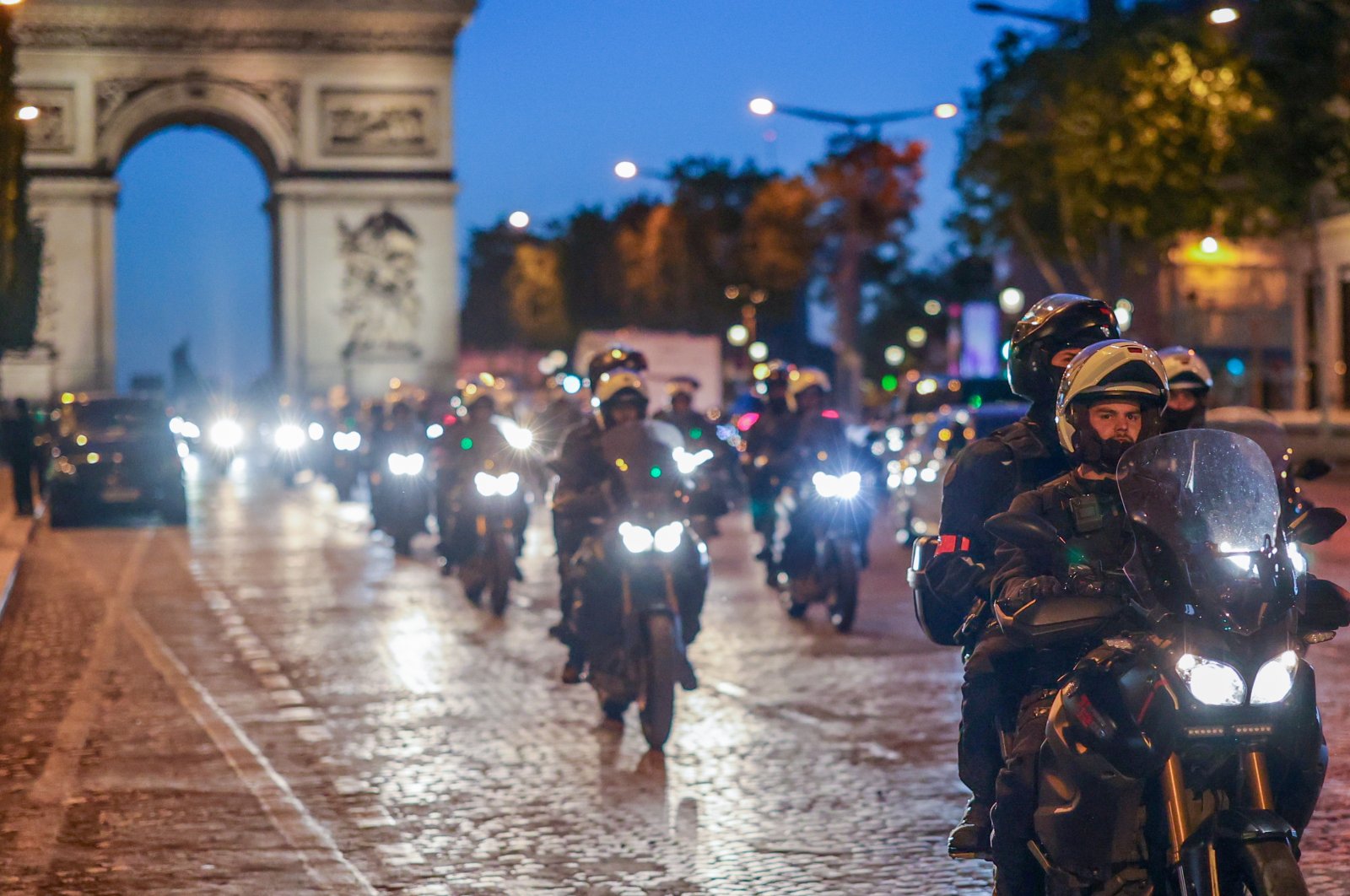 Riot police forces on motorbikes secure the area in front of the Arc de Triomphe amid fears of another night of clashes with protestors in Paris, France, July 2, 2023. (EPA Photo)