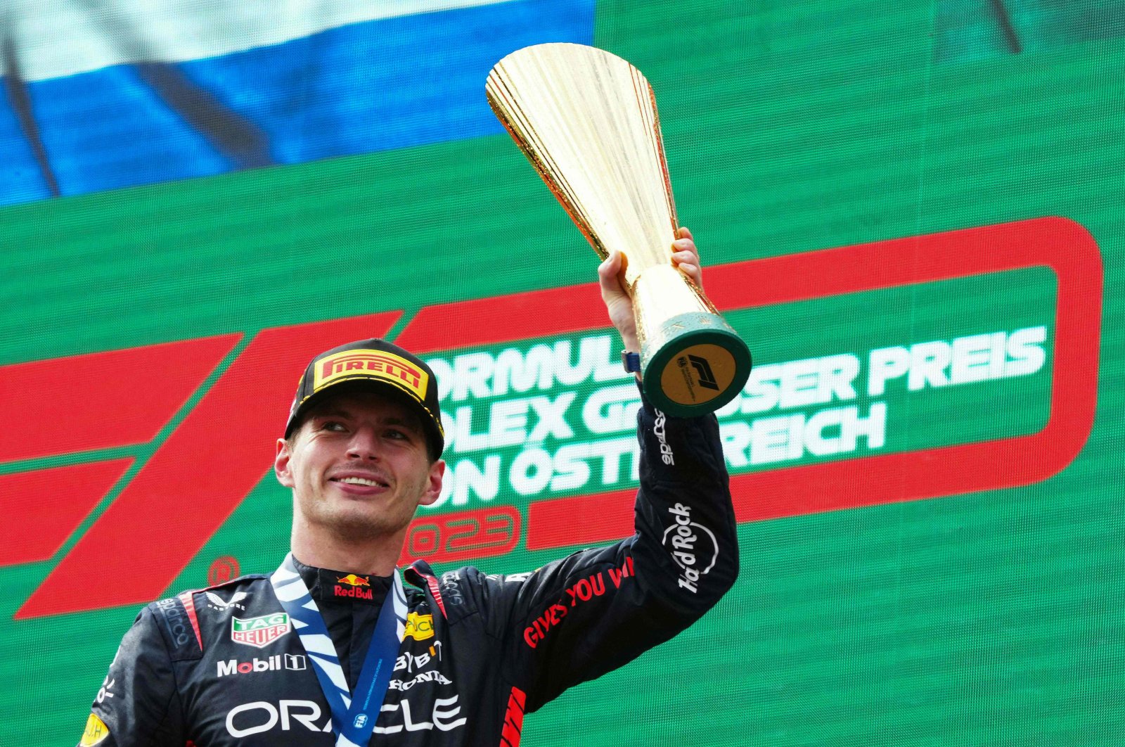 Winner Red Bull Racing&#039;s Dutch driver Max Verstappen celebrates the podium after the Formula One Austrian Grand Prix at the Red Bull race track, Spielberg, Austria, July 2, 2023. (AFP Photo)