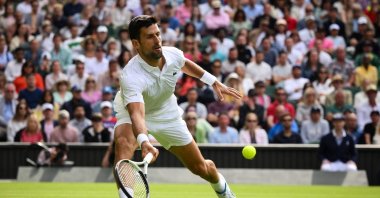 Serbia's Novak Djokovic returns the ball to Argentina's Pedro Cachin during their men's singles tennis match on the first day of the 2023 Wimbledon Championships at The All England Tennis Club in Wimbledon, London, UK., July 3, 2023. (AFP Photo)