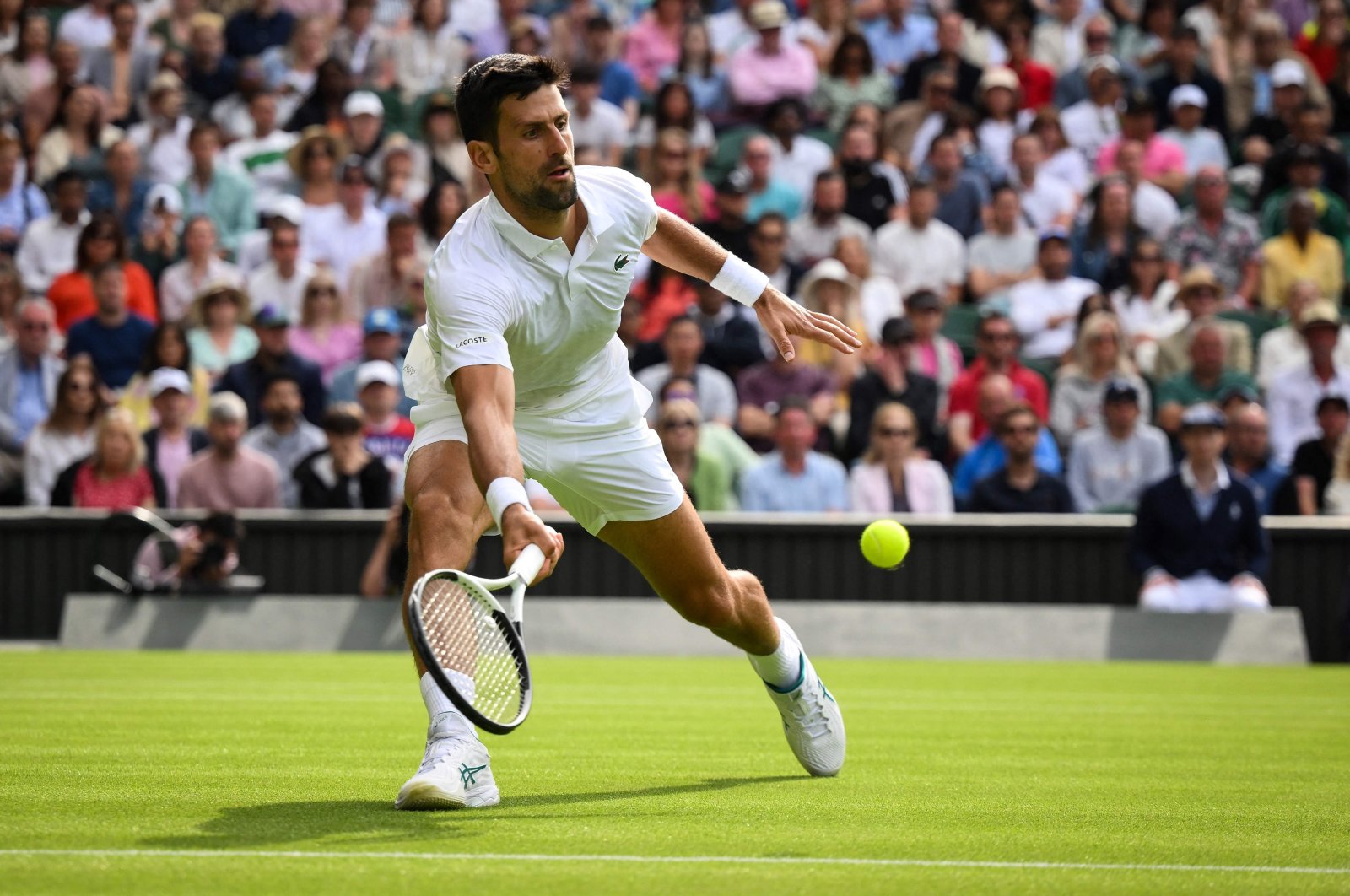 Serbia&#039;s Novak Djokovic returns the ball to Argentina&#039;s Pedro Cachin during their men&#039;s singles tennis match on the first day of the 2023 Wimbledon Championships at The All England Tennis Club in Wimbledon, London, UK., July 3, 2023. (AFP Photo)