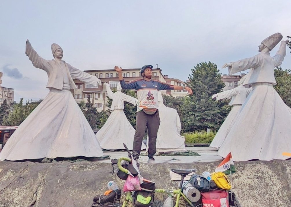 Fayis Asraf Ali posing with statues of sufis in Konya, Türkiye, July 5, 2023. (Photo by Fayis Asraf)