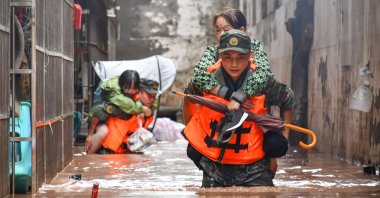 Chinese People&#039;s Armed Police Force members evacuate flood-trapped residents in Wanzhou District in Chongqing, southwest China, July 4, 2023.